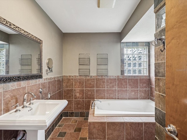 5110 Lake Valencia Blvd E, Palm Harbor, FL 34684 - full bathroom with tiled tub and tile walls
