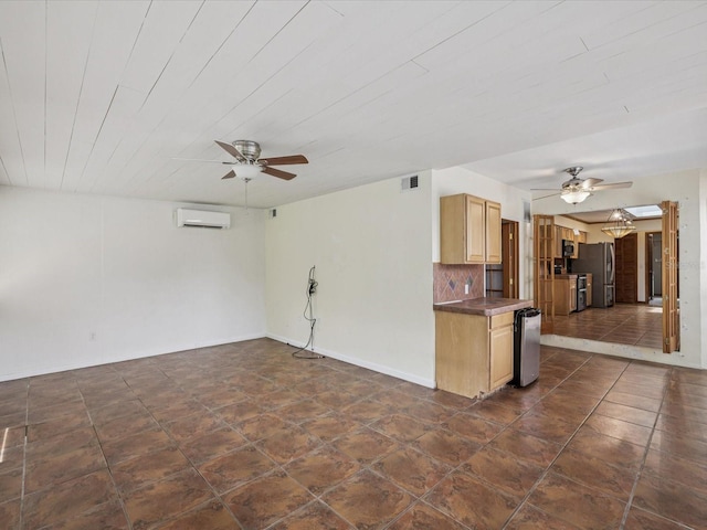 5110 Lake Valencia Blvd E, Palm Harbor, FL 34684 - kitchen featuring a ceiling fan, a wall mounted AC, freestanding refrigerator, dark countertops, and light brown cabinetry