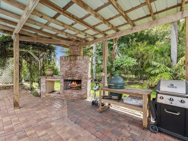 5110 Lake Valencia Blvd E, Palm Harbor, FL 34684 - view of patio / terrace with an outdoor brick fireplace and area for grilling