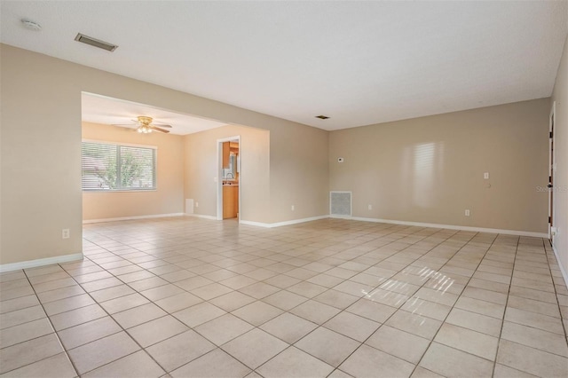 1328 Glenview Ln, Lakeland, FL 33813 - spare room featuring light tile patterned floors, a smoke detector, and a ceiling fan