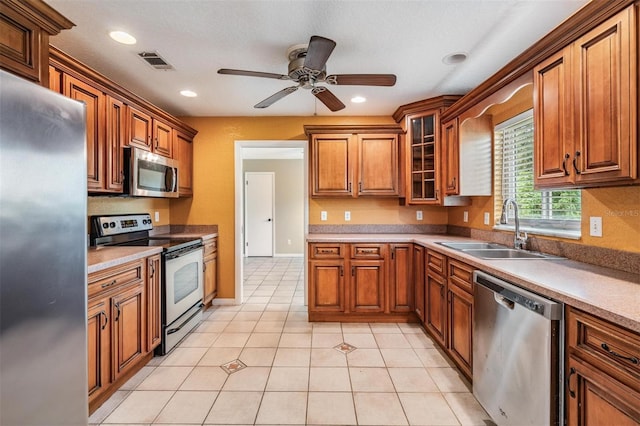 1328 Glenview Ln, Lakeland, FL 33813 - kitchen featuring appliances with stainless steel finishes, brown cabinets, a ceiling fan, and recessed lighting