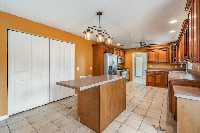 1328 Glenview Ln, Lakeland, FL 33813 - kitchen with appliances with stainless steel finishes, brown cabinetry, a ceiling fan, recessed lighting, and glass insert cabinets
