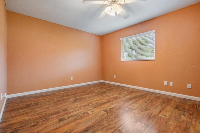1328 Glenview Ln, Lakeland, FL 33813 - spare room featuring wood finished floors and a ceiling fan