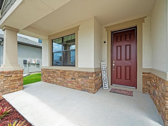 13638 Moosehead Cir, Hudson, FL 34669 - entrance to property featuring stone siding, stucco siding, and a porch