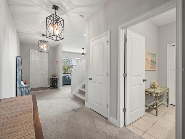 13638 Moosehead Cir, Hudson, FL 34669 - hall with stairs, a chandelier, light colored carpet, and light tile patterned flooring