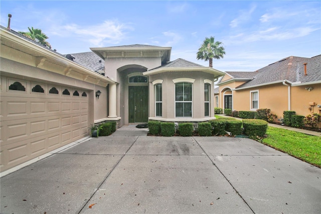 2802 Devonoak Blvd, Land O Lakes, FL 34638 - view of front of house with stucco siding, concrete driveway, an attached garage, and a shingled roof