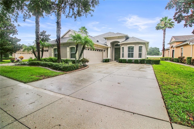 2802 Devonoak Blvd, Land O Lakes, FL 34638 - view of front facade with a garage, concrete driveway, stucco siding, and a front lawn