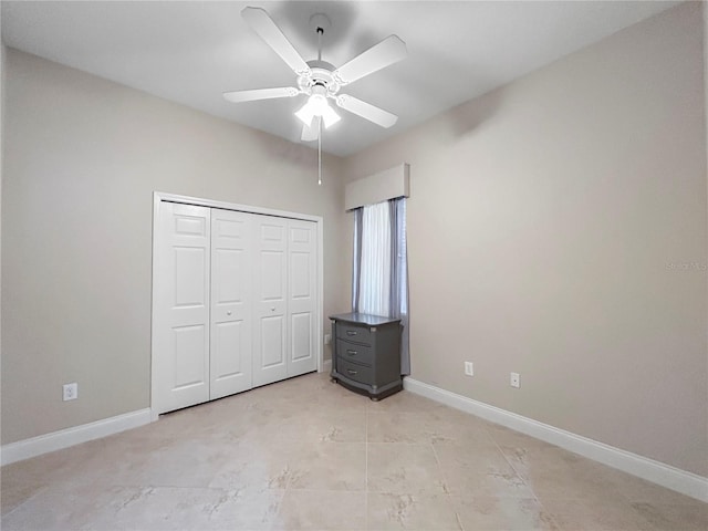 2802 Devonoak Blvd, Land O Lakes, FL 34638 - unfurnished bedroom with a closet, a ceiling fan, and light tile patterned flooring