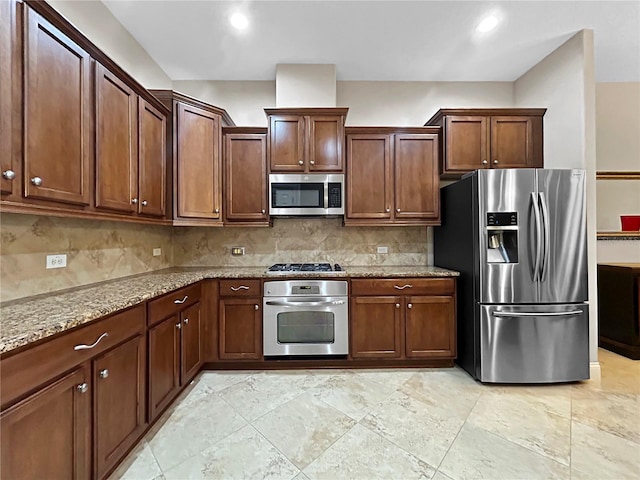 2802 Devonoak Blvd, Land O Lakes, FL 34638 - kitchen with stainless steel appliances, tasteful backsplash, light stone countertops, and recessed lighting