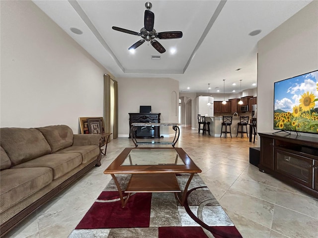 2802 Devonoak Blvd, Land O Lakes, FL 34638 - living room featuring arched walkways, ceiling fan, recessed lighting, and a raised ceiling