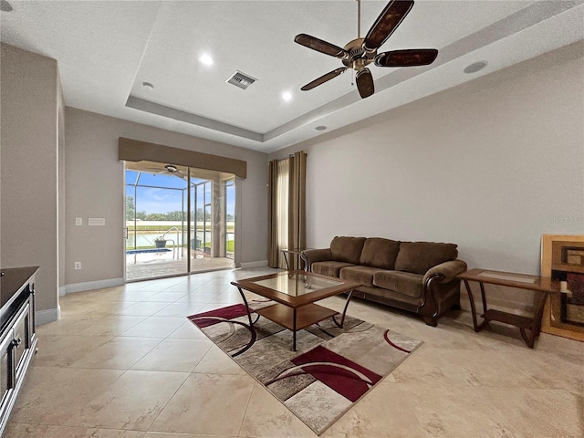 2802 Devonoak Blvd, Land O Lakes, FL 34638 - living area with a ceiling fan, a tray ceiling, recessed lighting, and a water view