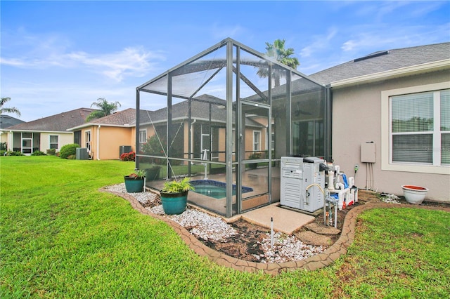 2802 Devonoak Blvd, Land O Lakes, FL 34638 - back of house with a lawn, an outdoor pool, stucco siding, and glass enclosure