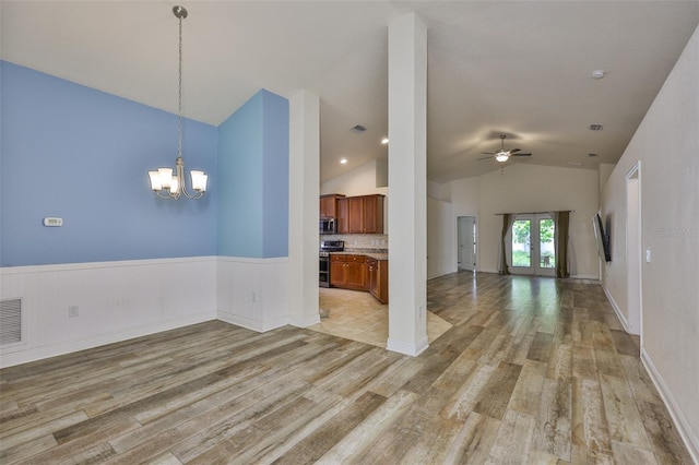 12218 Avondale Oak Pl, Riverview, FL 33578 - unfurnished living room with light wood-style floors, vaulted ceiling, a ceiling fan, a chandelier, and a wainscoted wall