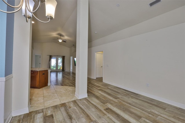 12218 Avondale Oak Pl, Riverview, FL 33578 - spare room featuring light wood-type flooring, lofted ceiling, a ceiling fan, and a chandelier