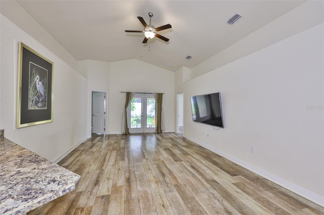 12218 Avondale Oak Pl, Riverview, FL 33578 - unfurnished living room with french doors, ceiling fan, light wood-type flooring, and high vaulted ceiling