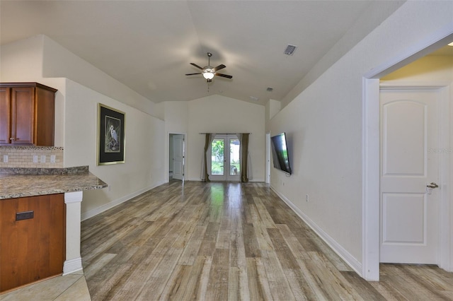 12218 Avondale Oak Pl, Riverview, FL 33578 - unfurnished living room featuring ceiling fan, light wood-style floors, vaulted ceiling, and french doors