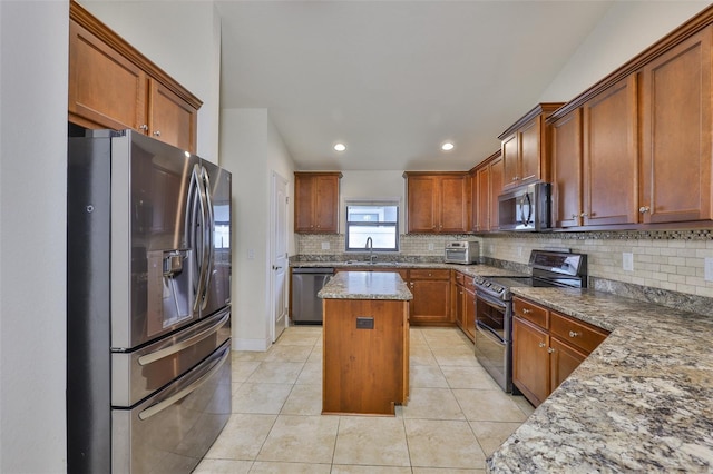 12218 Avondale Oak Pl, Riverview, FL 33578 - kitchen featuring stainless steel appliances, tasteful backsplash, a kitchen island, light tile patterned flooring, and light stone countertops
