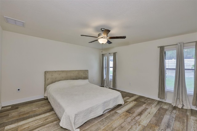 12218 Avondale Oak Pl, Riverview, FL 33578 - bedroom with wood finished floors and a ceiling fan