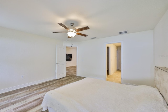 12218 Avondale Oak Pl, Riverview, FL 33578 - bedroom with ceiling fan and light wood-style flooring