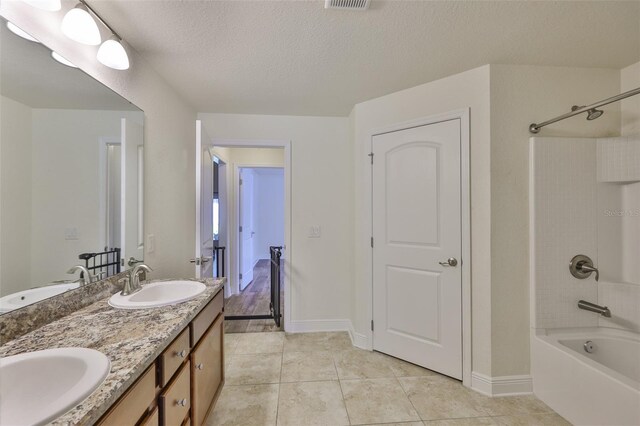 12218 Avondale Oak Pl, Riverview, FL 33578 - bathroom with bathtub / shower combination, tile patterned flooring, double vanity, and a textured ceiling