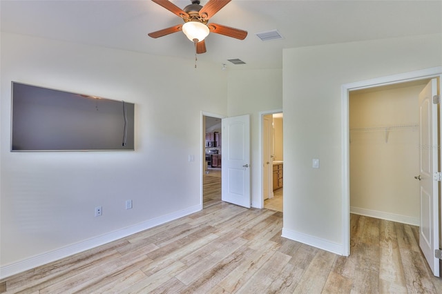 12218 Avondale Oak Pl, Riverview, FL 33578 - unfurnished bedroom with a spacious closet, lofted ceiling, wood finished floors, a closet, and ceiling fan
