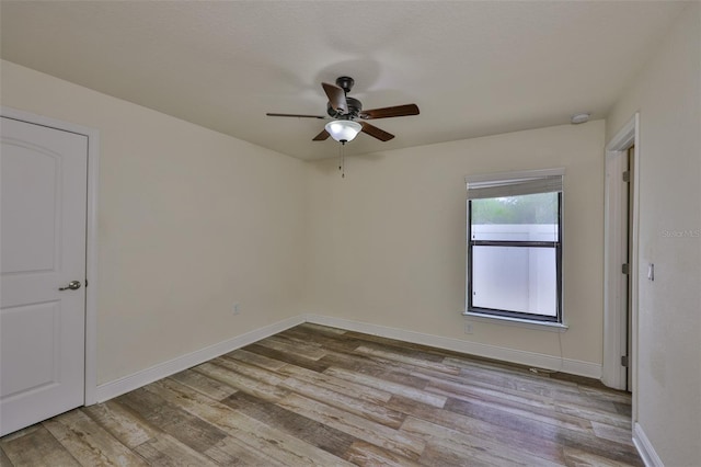 12218 Avondale Oak Pl, Riverview, FL 33578 - empty room featuring a ceiling fan, wood finished floors, and a smoke detector