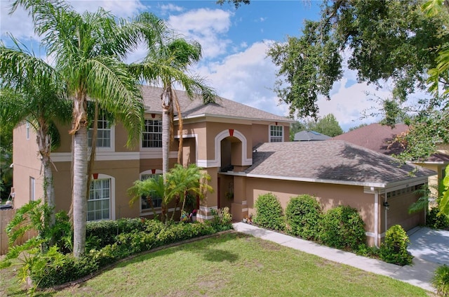 4222 Trumpworth Ct, Valrico, FL 33596 - view of front of home featuring stucco siding, an attached garage, a front lawn, roof with shingles, and concrete driveway