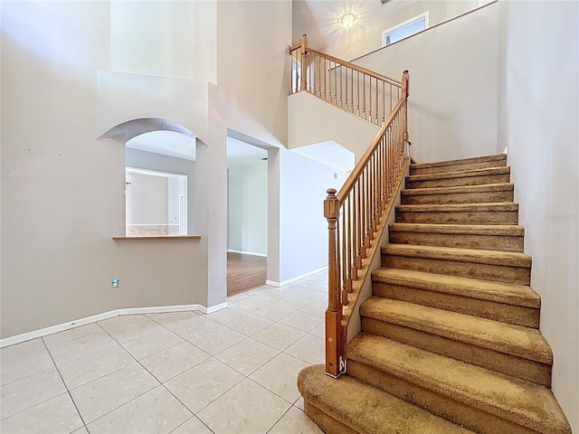 4222 Trumpworth Ct, Valrico, FL 33596 - stairs with tile patterned floors and a towering ceiling