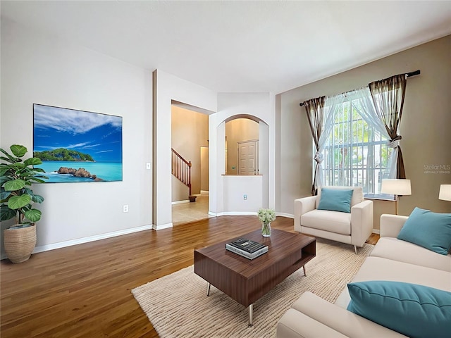 4222 Trumpworth Ct, Valrico, FL 33596 - living area featuring wood finished floors, arched walkways, and stairway