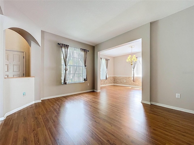 4222 Trumpworth Ct, Valrico, FL 33596 - empty room with a chandelier, healthy amount of natural light, and wood finished floors