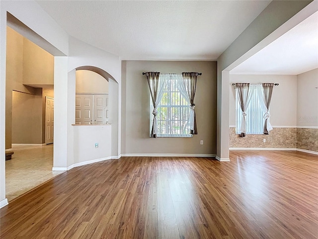 4222 Trumpworth Ct, Valrico, FL 33596 - spare room featuring wood finished floors and arched walkways