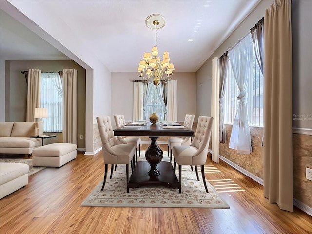 4222 Trumpworth Ct, Valrico, FL 33596 - dining room with a chandelier, healthy amount of natural light, and wood finished floors