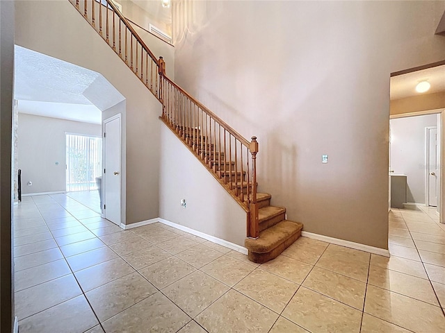 4222 Trumpworth Ct, Valrico, FL 33596 - stairs with tile patterned flooring and a towering ceiling