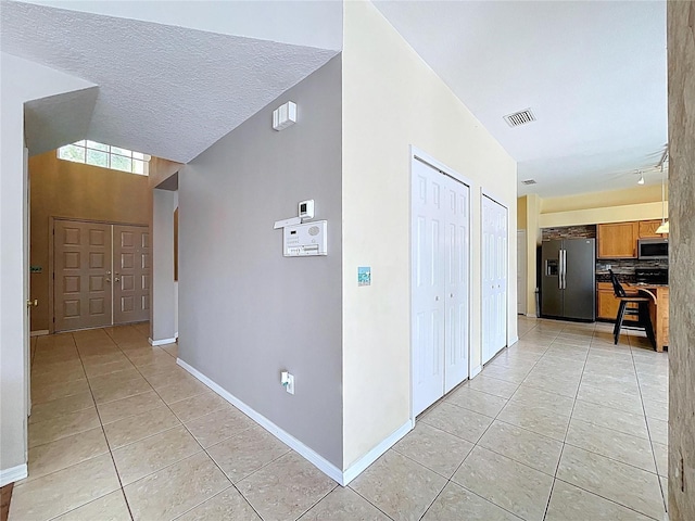 4222 Trumpworth Ct, Valrico, FL 33596 - hallway featuring light tile patterned floors and track lighting