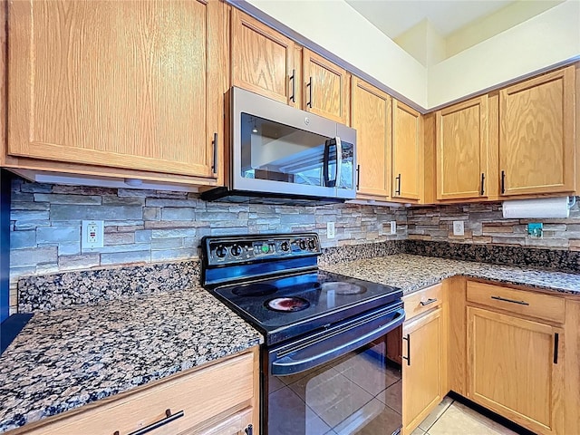 4222 Trumpworth Ct, Valrico, FL 33596 - kitchen featuring black range with electric cooktop, stainless steel microwave, light brown cabinets, and light tile patterned flooring