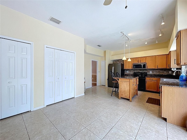 4222 Trumpworth Ct, Valrico, FL 33596 - kitchen with black appliances, light tile patterned floors, and tasteful backsplash