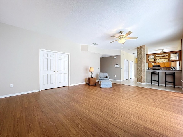 4222 Trumpworth Ct, Valrico, FL 33596 - unfurnished living room featuring ceiling fan and light wood-type flooring