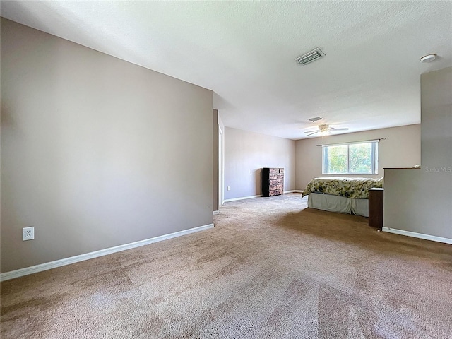 4222 Trumpworth Ct, Valrico, FL 33596 - unfurnished living room with carpet flooring, ceiling fan, and a stone fireplace