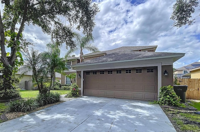 4222 Trumpworth Ct, Valrico, FL 33596 - view of front of house with roof with shingles, an attached garage, driveway, and stucco siding
