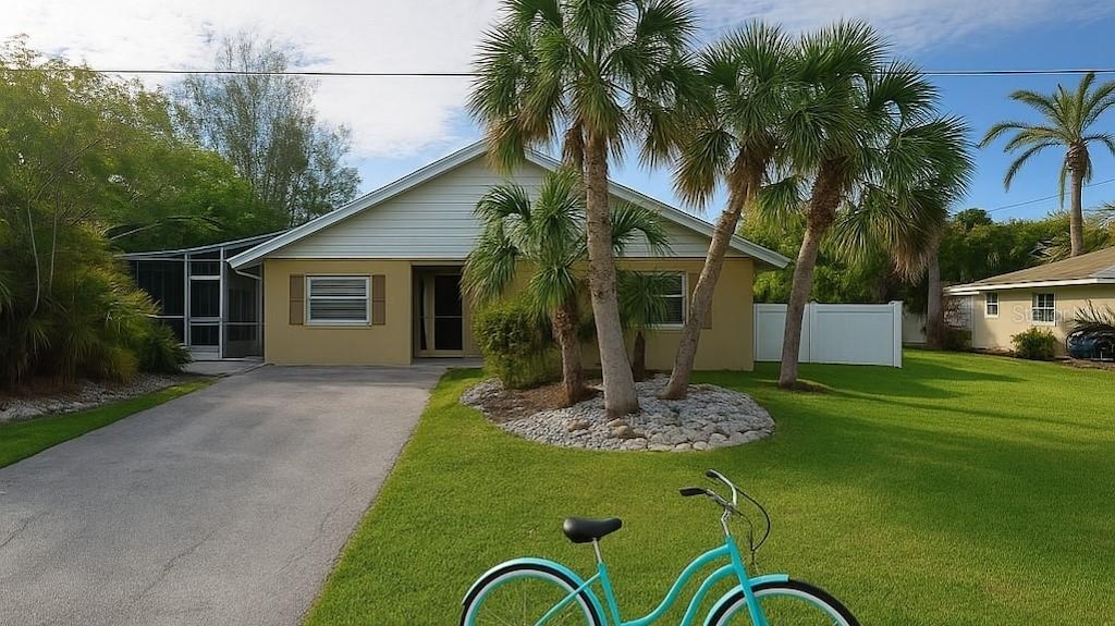 210 84th St, Holmes Beach, FL 34217 - view of front of house with driveway and stucco siding
