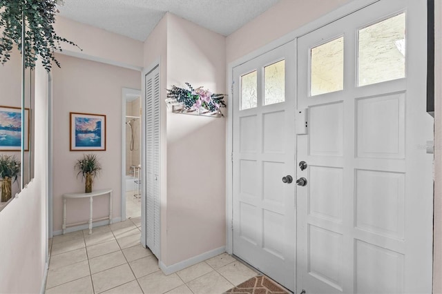 630 Windrush Bay Dr Unit 630, Tarpon Springs, FL 34689 - foyer entrance featuring light tile patterned flooring and a textured ceiling