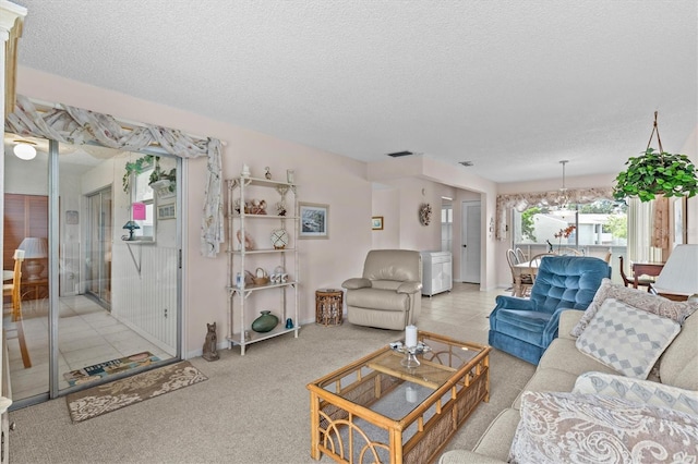 630 Windrush Bay Dr Unit 630, Tarpon Springs, FL 34689 - living area with a textured ceiling, carpet floors, and a chandelier