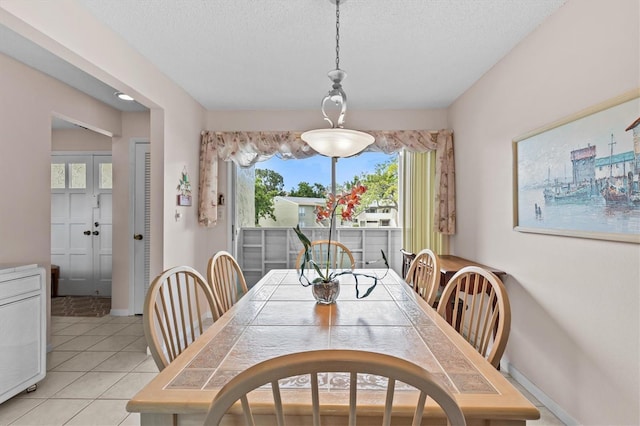 630 Windrush Bay Dr Unit 630, Tarpon Springs, FL 34689 - dining room with a textured ceiling and light tile patterned floors