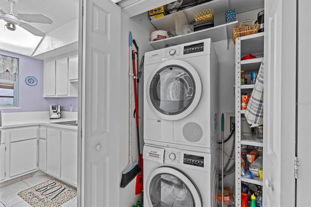 630 Windrush Bay Dr Unit 630, Tarpon Springs, FL 34689 - washroom featuring estacked washer and dryer, a ceiling fan, and light tile patterned floors