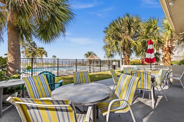 630 Windrush Bay Dr Unit 630, Tarpon Springs, FL 34689 - view of patio / terrace featuring outdoor dining area and a community pool