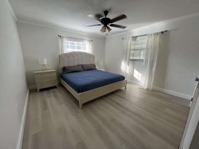3856 Tarpon Rd, Venice, FL 34293 - bedroom featuring crown molding, light wood-style floors, a textured ceiling, and a ceiling fan