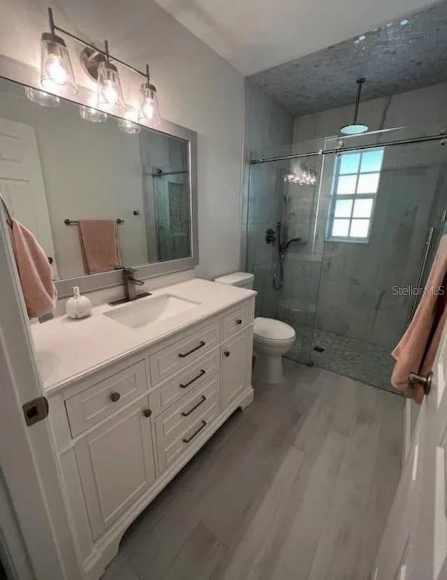 3856 Tarpon Rd, Venice, FL 34293 - bathroom featuring a stall shower, vanity, and wood finished floors