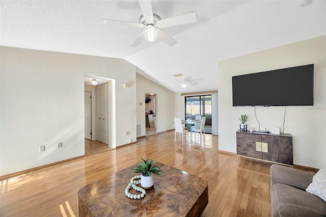 3302 69th St W, Bradenton, FL 34209 - living area featuring light wood-style flooring, vaulted ceiling, and ceiling fan