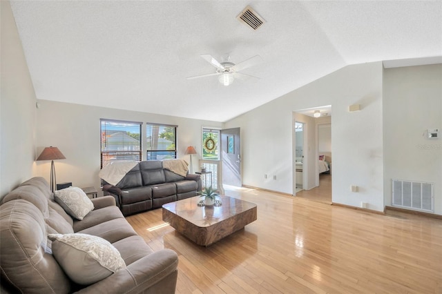 3302 69th St W, Bradenton, FL 34209 - living room featuring vaulted ceiling, ceiling fan, light wood-type flooring, and a textured ceiling