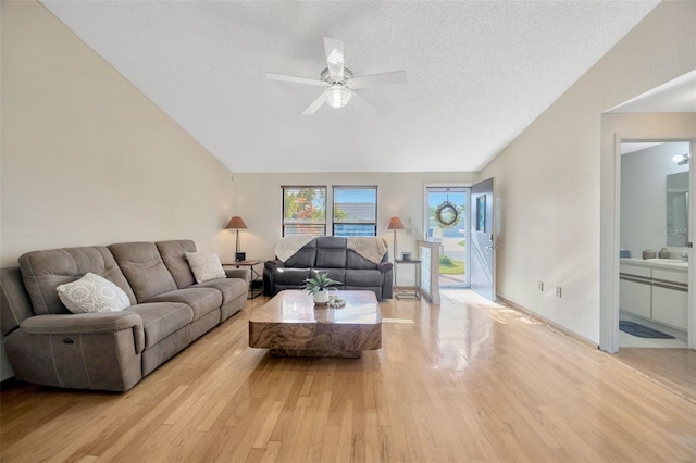 3302 69th St W, Bradenton, FL 34209 - living area with lofted ceiling, light wood-style flooring, ceiling fan, and a textured ceiling